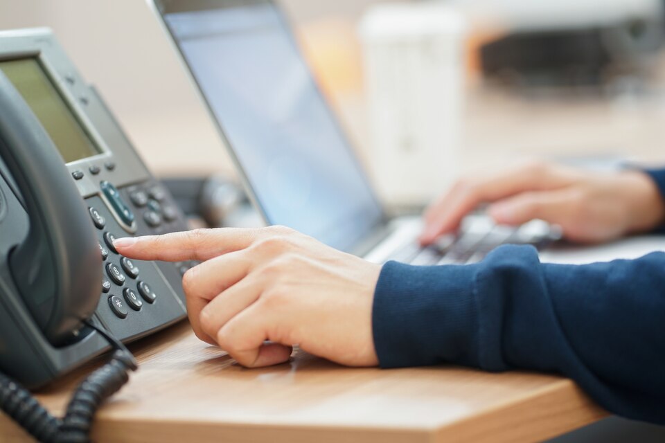 freepicdownloader.com-employee-man-hand-press-number-telephone-contact-with-someone-large